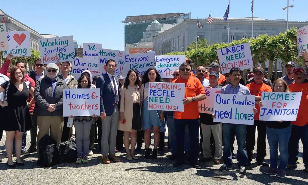 Group of YIMBYs carrying signs that read "Homes for Teachers", "Working People Need Housing", "Homes for Janitors", and similar slogans