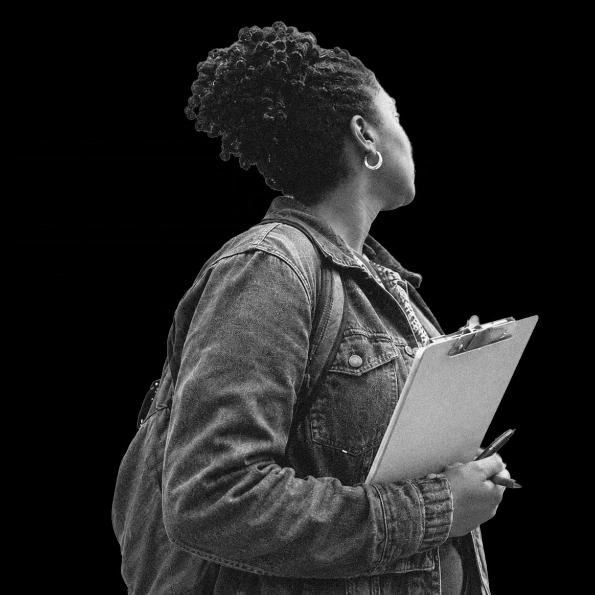 A YIMBY volunteer with a clipboard looking up