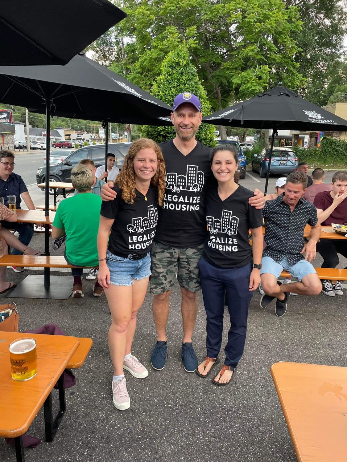 Three volunteers in Legalize Housing shirts at an outdoor chapter meetup