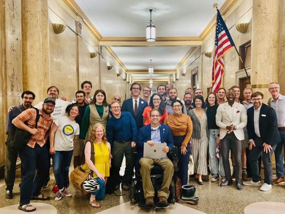 YIMBY Denver members and allies gathered in the hallway of Denver City and County Building after the parking reform vote