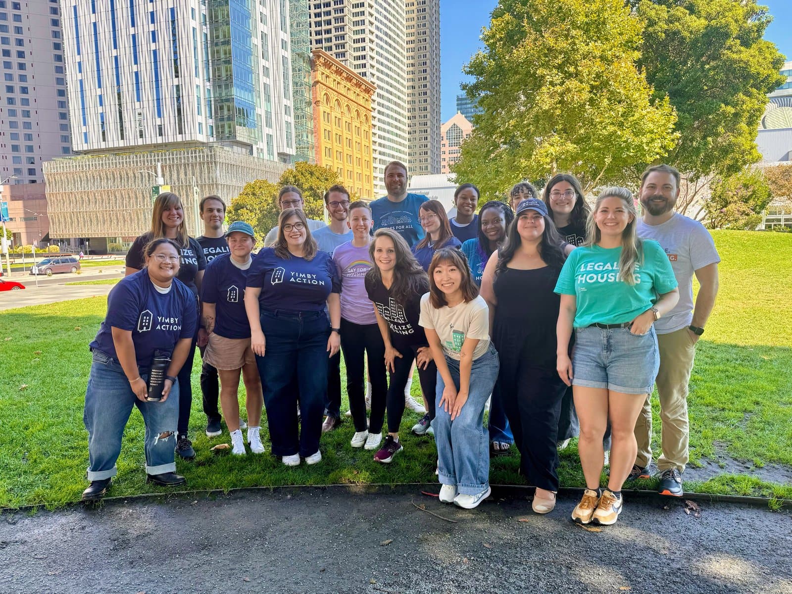 The YIMBY Action staff in Legalize Housing shirts on a lawn in downtown San Francisco